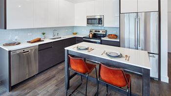 High-gloss white upper cabinets and wood lower cabinets